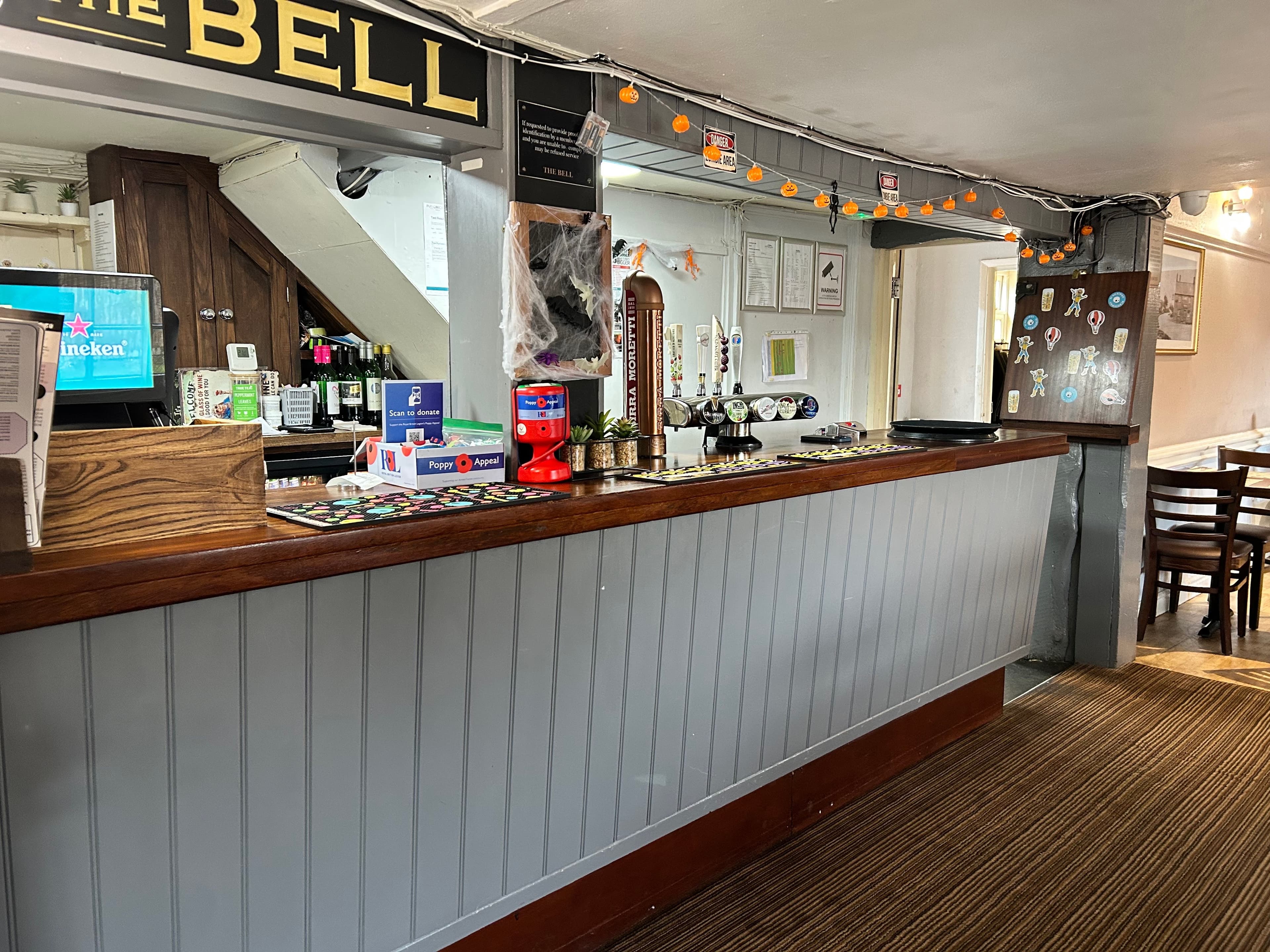 Beer being poured at the bar inside The Bell pub in Sawtry.